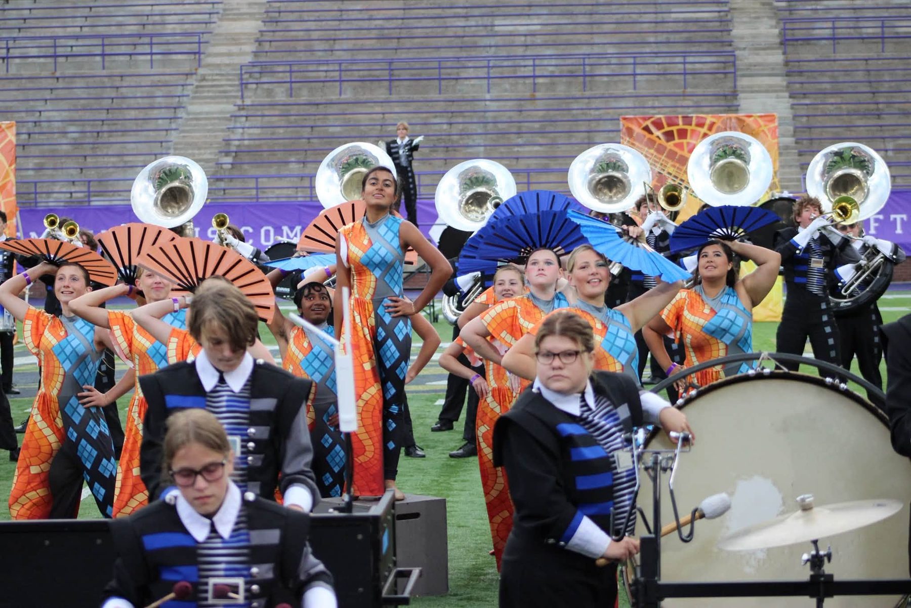 Farragut color guard posing with fans during a halftime show